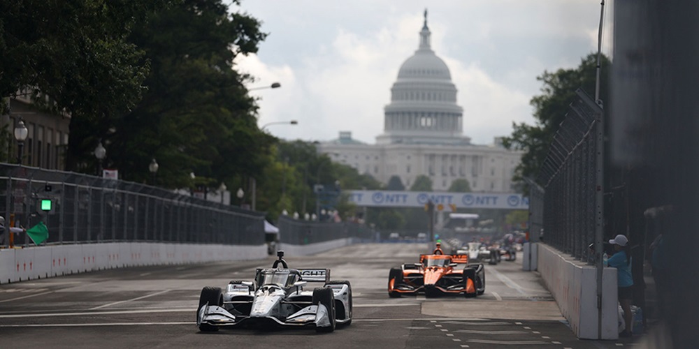 Cars race in front of the Capitol