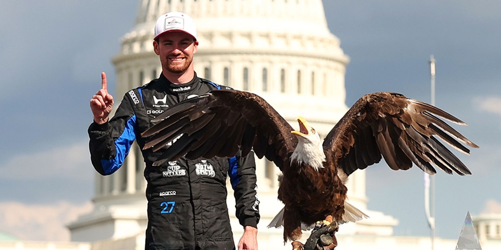 Kyle Kirkwood poses with Lincoln the Bald Eagle